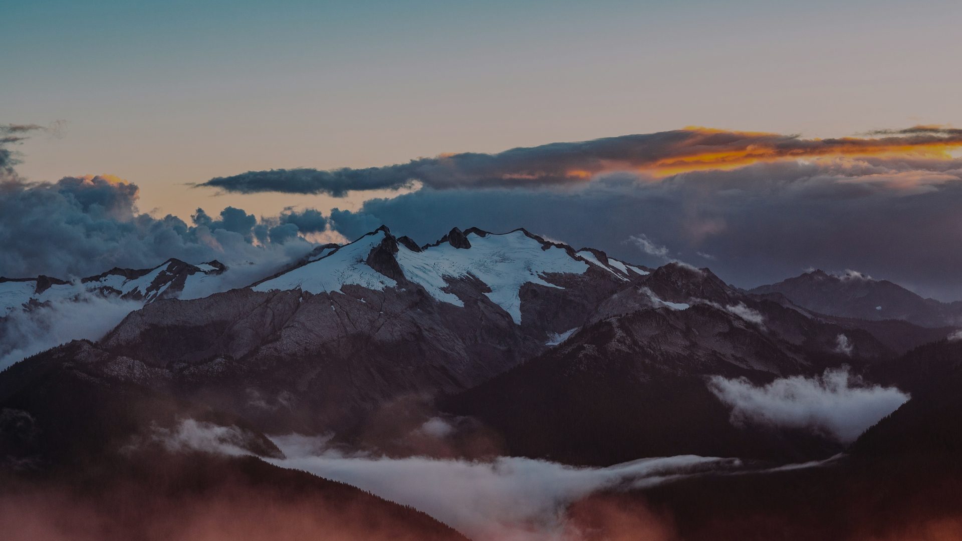 Snowy mountain range at sunset